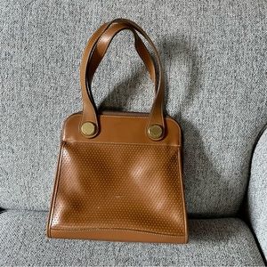 Dooney and Bourke medium size top handle tote style bag.